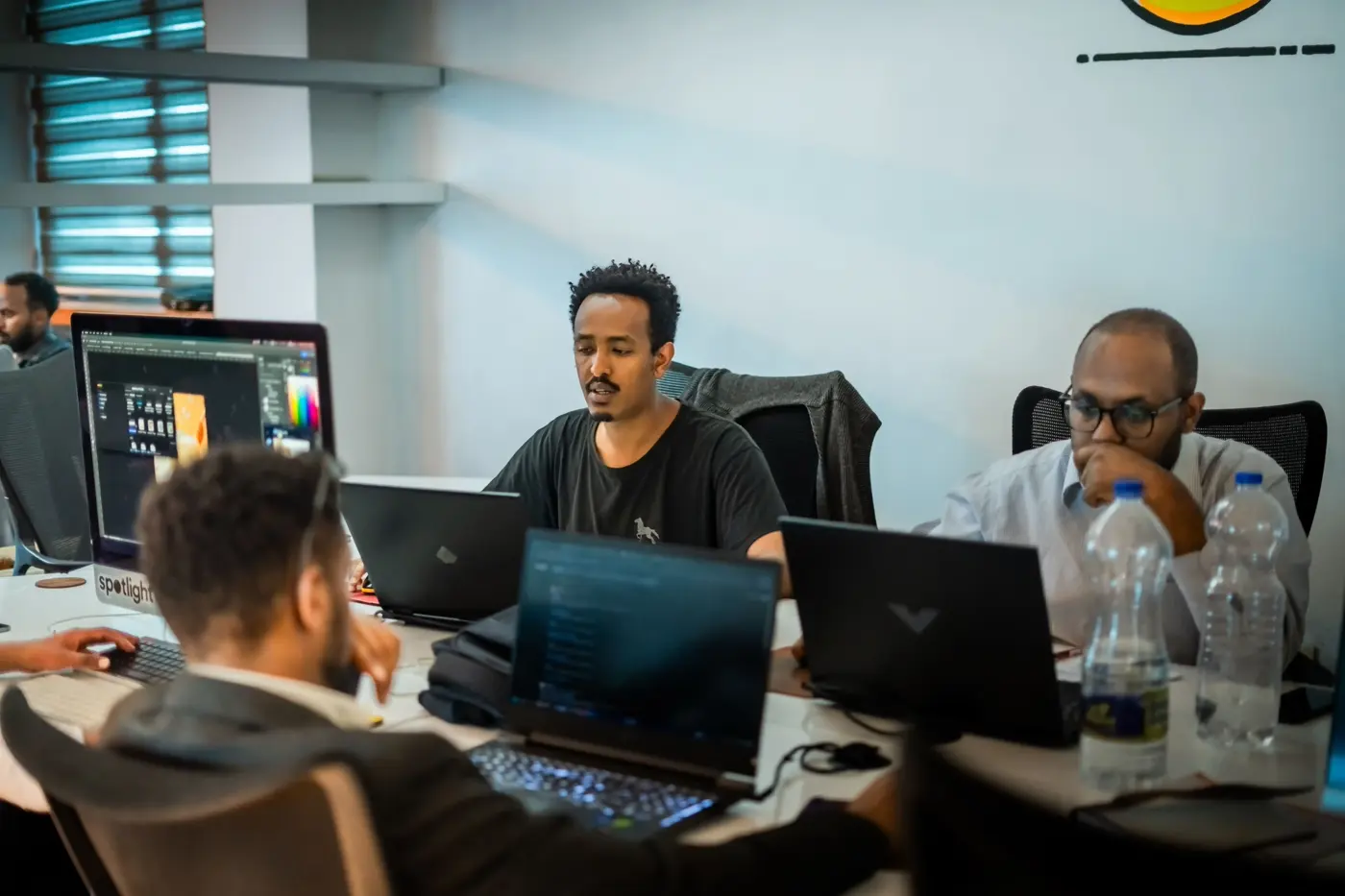 Certa outsourcing office team collaborating on workstations